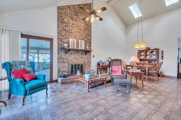 a living room with furniture a fireplace and a chandelier