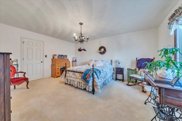 a bedroom with furniture and a chandelier