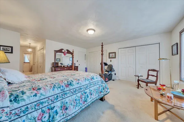 a bedroom with a bed and dresser