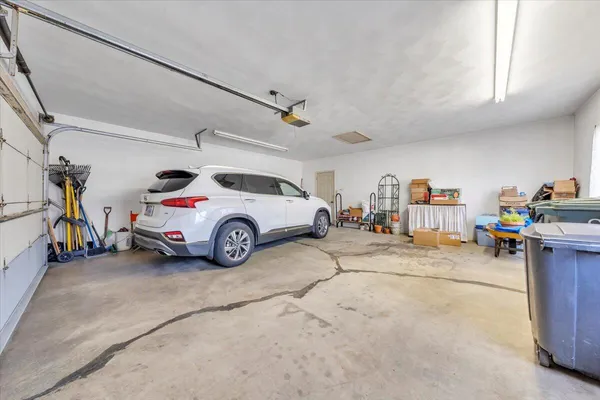 a view of parking garage with cars and other equipment