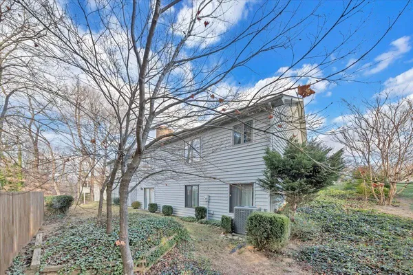 a house that has a tree in front of it