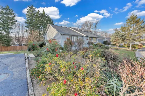 a view of a house with a yard and garden