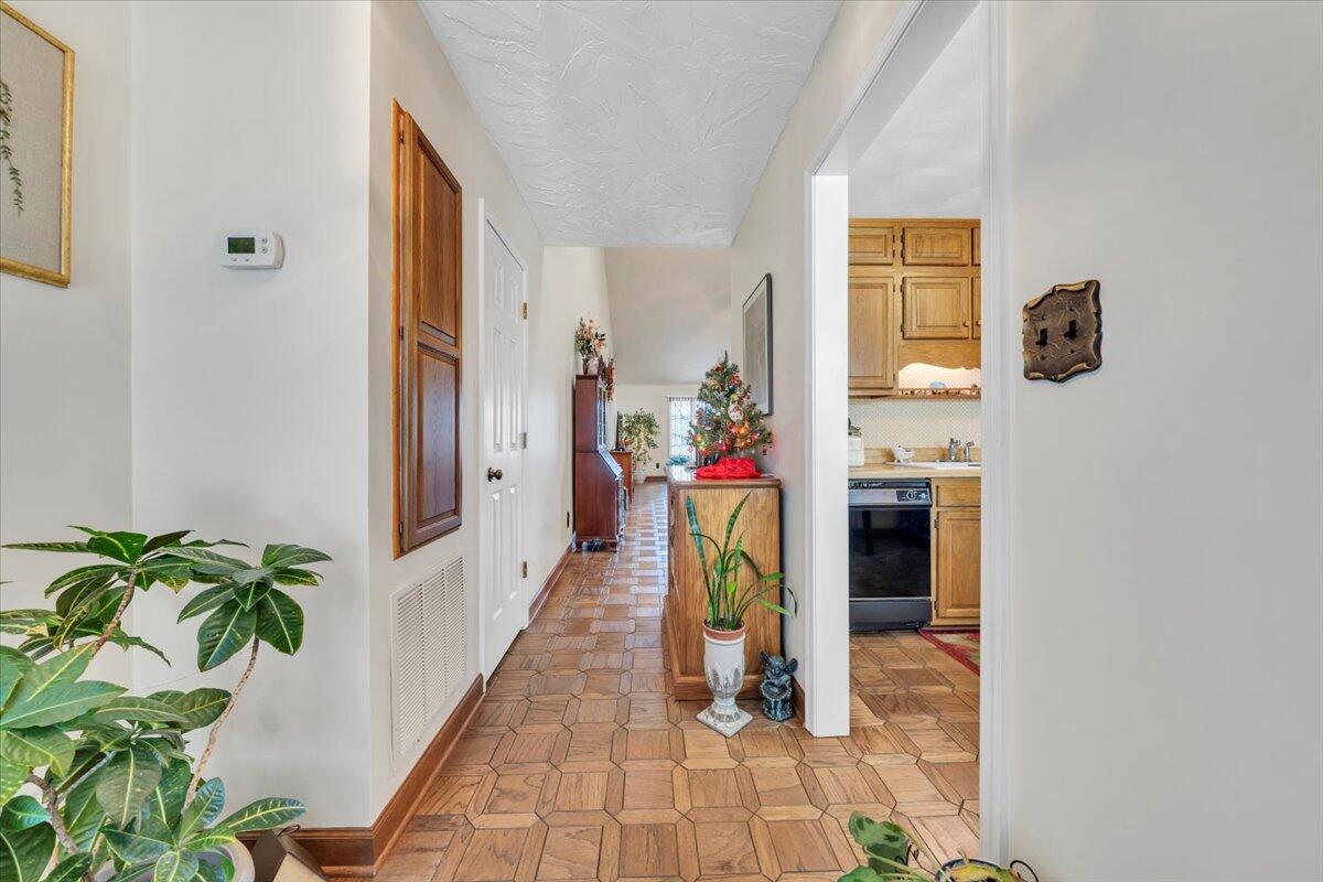 2409 South Clearing Road Salem, VA 24153 - Photo 5 of 45 a view of a hallway with wooden floor and a potted plant