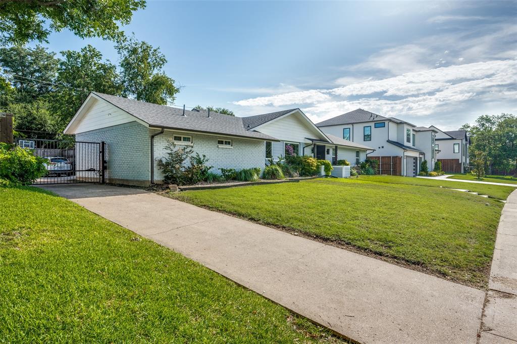 3619 Merrell Road Dallas, TX 75229 - Photo 3 of 26 Expansive front lawn with a concrete driveway leading to a gated entry