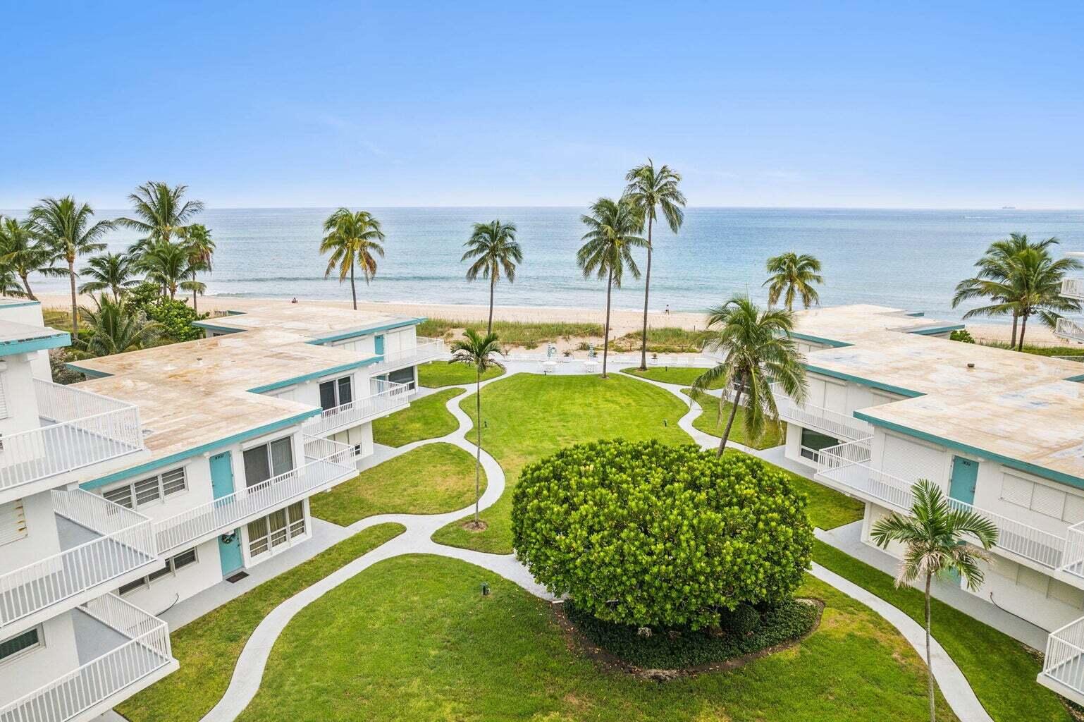 1470 South Ocean Boulevard, Unit 901 Lauderdale-by-the-Sea, FL 33062 - Photo 1 of 13 a view of a swimming pool with a lawn chairs and potted plants