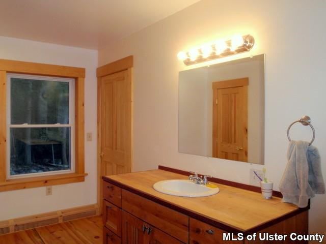 628 Buck Road, Unit STONE RIDGE Stone Ridge, NY 12484 - Photo 8 of 17 a bathroom with a sink and a mirror