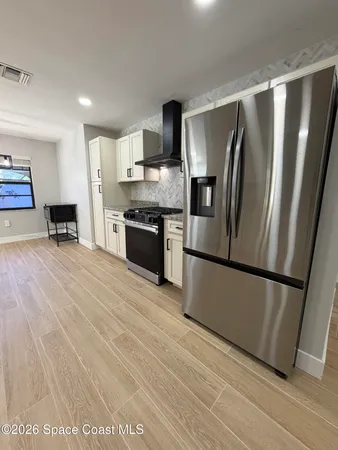 a open kitchen with cabinets a sink and appliances