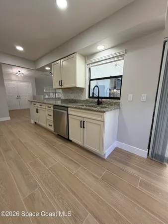 a stove top oven sitting inside of a kitchen