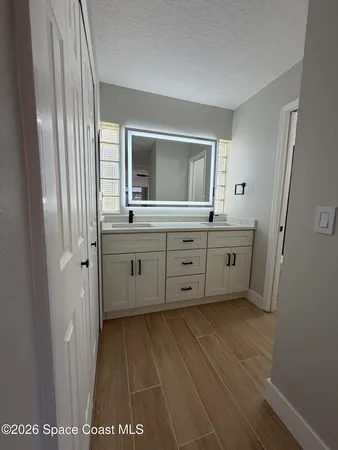 a bathroom with a double vanity sink and mirror