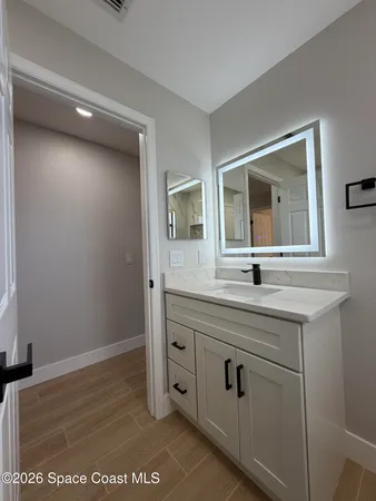 a bathroom with a tub a sink and mirror
