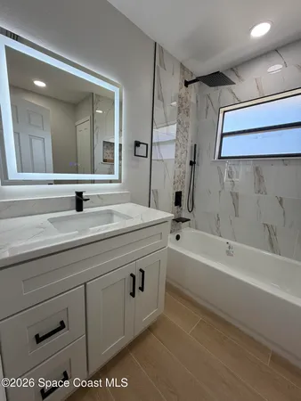 a bathroom with a bathtub and shower