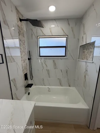 an empty room with a ceiling fan and window