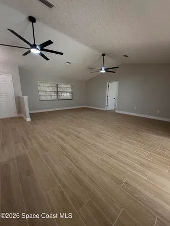 a large kitchen with stainless steel appliances kitchen island granite countertop a large counter top and a stove