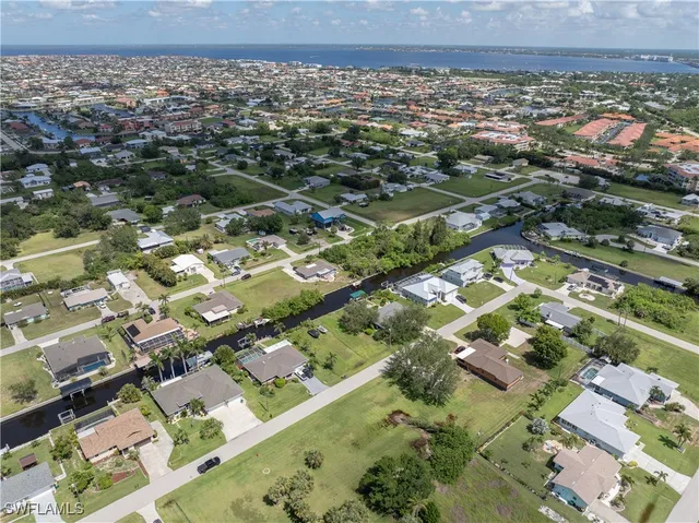 an aerial view of residential building with parking