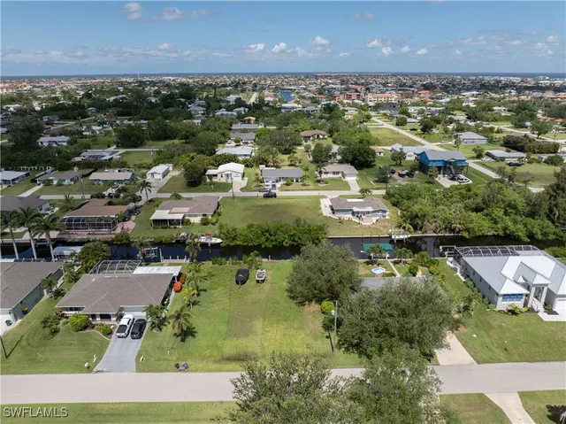 an aerial view of residential houses with outdoor space and river