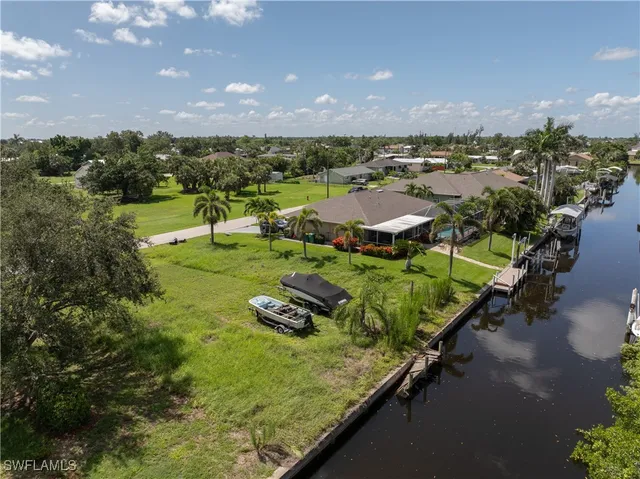 an aerial view of a house with yard swimming pool and outdoor seating