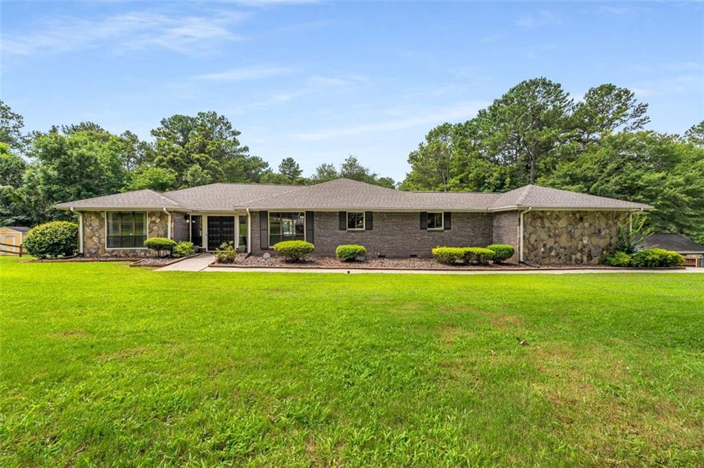 1535 Pathfinder Way Southwest Lilburn, GA 30047 - Photo 1 of 58 a front view of a house with yard patio and swimming pool