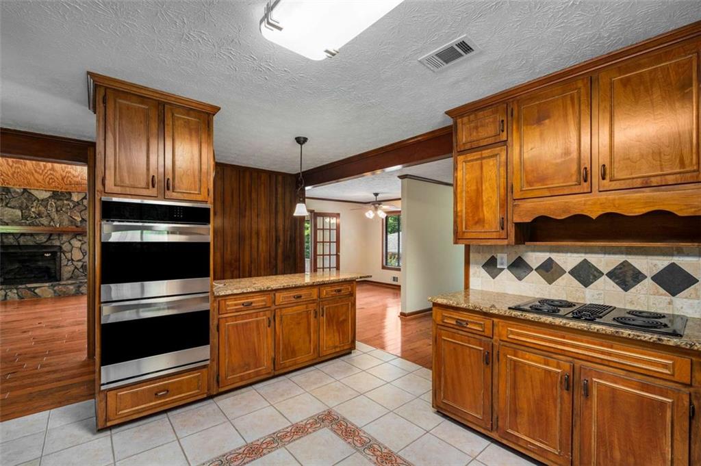 1535 Pathfinder Way Southwest Lilburn, GA 30047 - Photo 13 of 58 a kitchen with stainless steel appliances granite countertop a stove and a sink