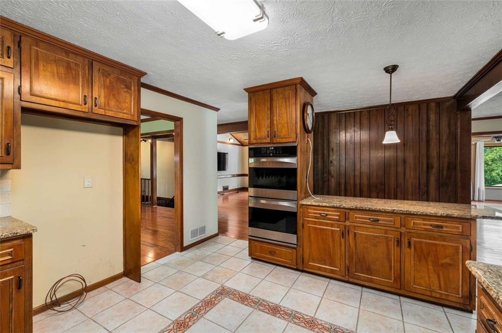 1535 Pathfinder Way Southwest Lilburn, GA 30047 - Photo 14 of 58 a kitchen with stainless steel appliances granite countertop a refrigerator and a stove top oven