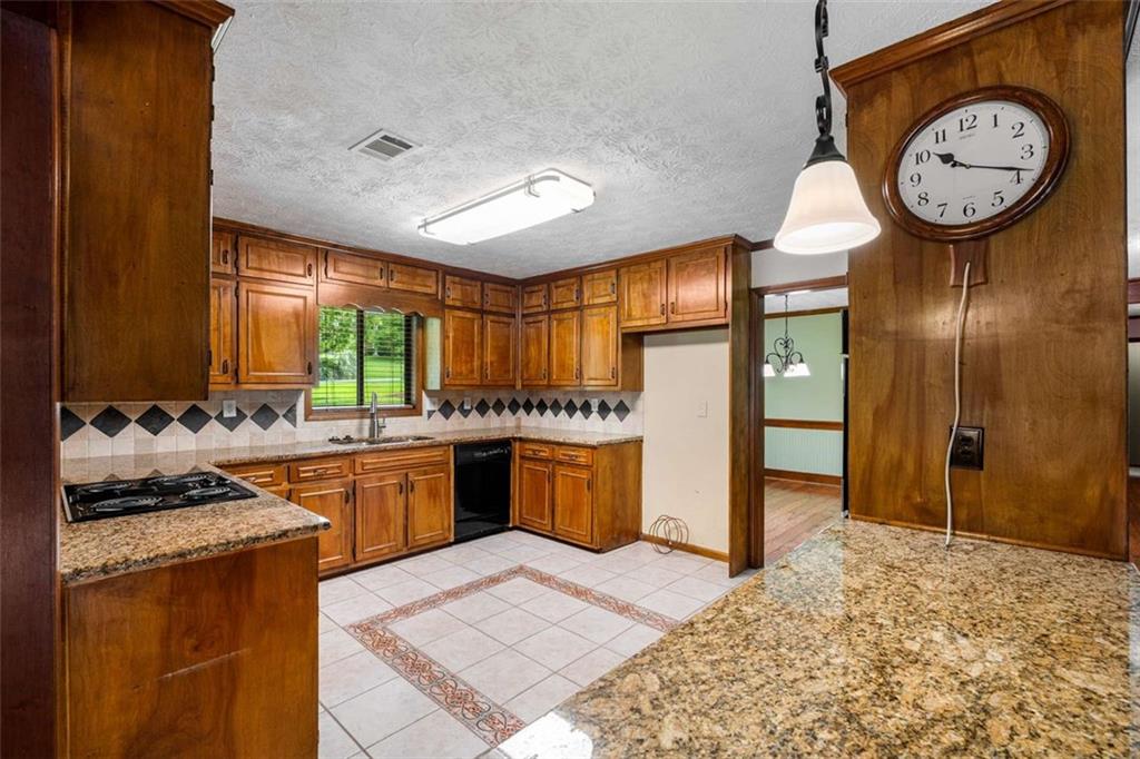1535 Pathfinder Way Southwest Lilburn, GA 30047 - Photo 15 of 58 a large kitchen with a stove a refrigerator and a sink