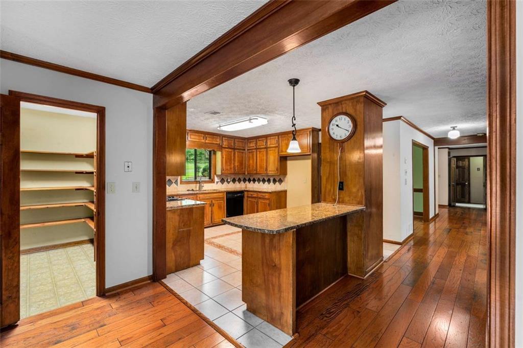 1535 Pathfinder Way Southwest Lilburn, GA 30047 - Photo 16 of 58 a kitchen with stainless steel appliances granite countertop a refrigerator a stove and a wooden floors