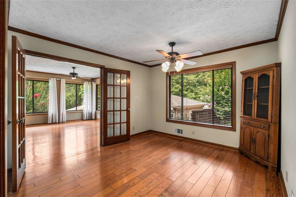 1535 Pathfinder Way Southwest Lilburn, GA 30047 - Photo 17 of 58 a view of an empty room with wooden floor and a window