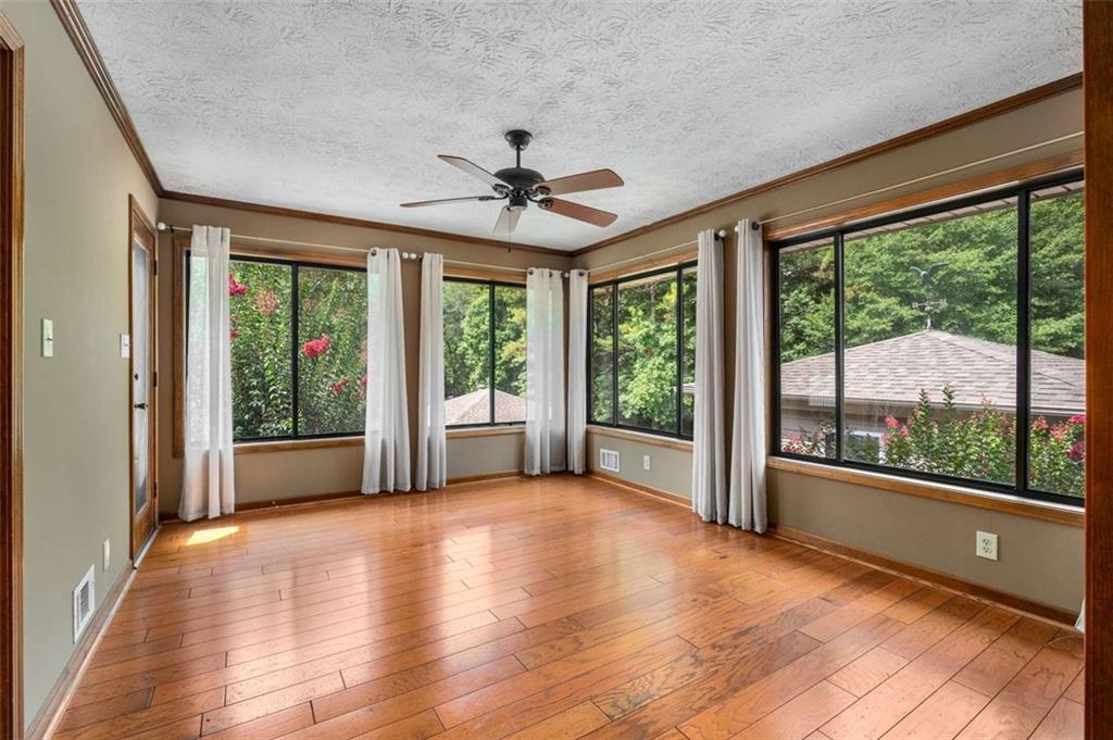 1535 Pathfinder Way Southwest Lilburn, GA 30047 - Photo 19 of 58 a view of a room with large windows and wooden floor