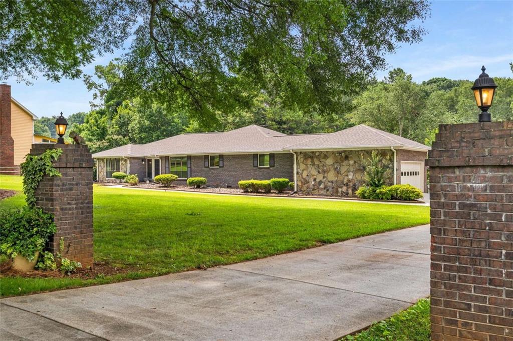 1535 Pathfinder Way Southwest Lilburn, GA 30047 - Photo 2 of 58 a front view of a house with garden