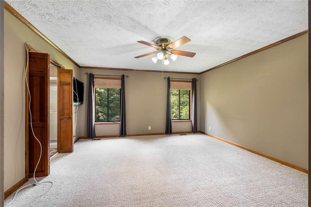 1535 Pathfinder Way Southwest Lilburn, GA 30047 - Photo 26 of 58 a view of a big room with windows and chandelier fan