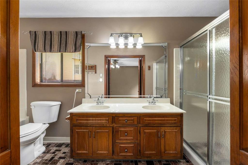 1535 Pathfinder Way Southwest Lilburn, GA 30047 - Photo 30 of 58 a bathroom with a double vanity sink and a mirror