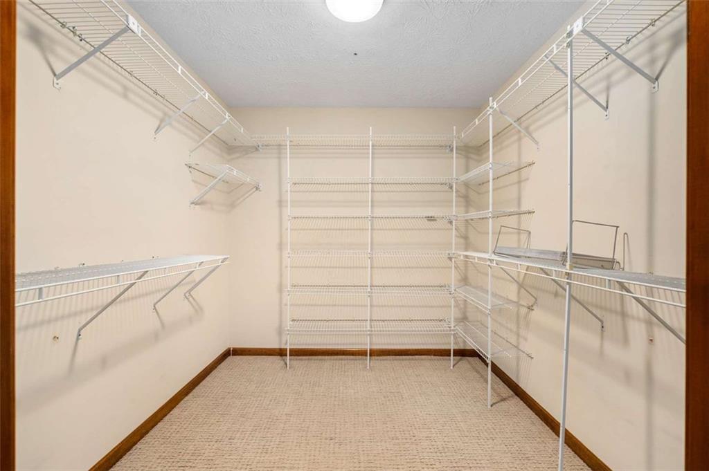 1535 Pathfinder Way Southwest Lilburn, GA 30047 - Photo 32 of 58 a view of walk in closet with empty racks