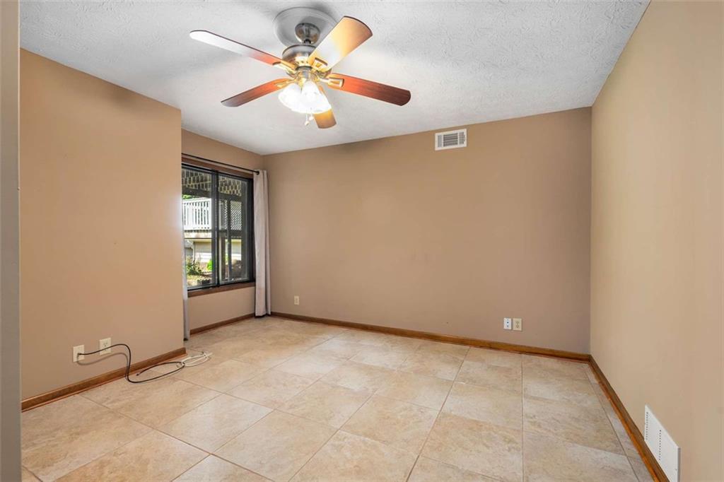 1535 Pathfinder Way Southwest Lilburn, GA 30047 - Photo 33 of 58 an empty room with windows and fan