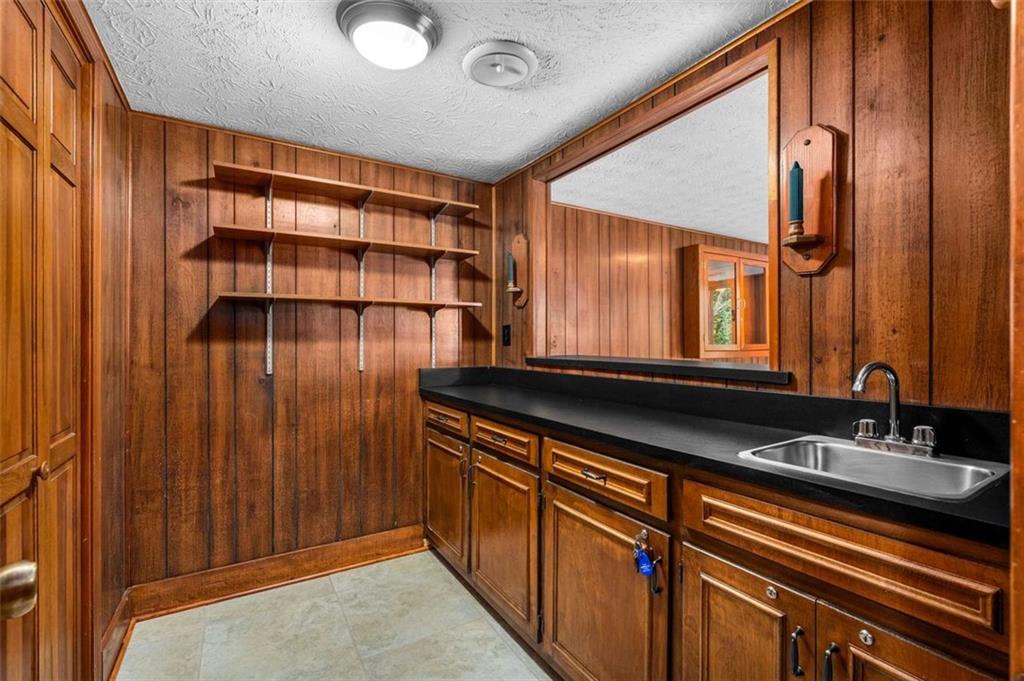 1535 Pathfinder Way Southwest Lilburn, GA 30047 - Photo 34 of 58 a bathroom with a sink and a mirror