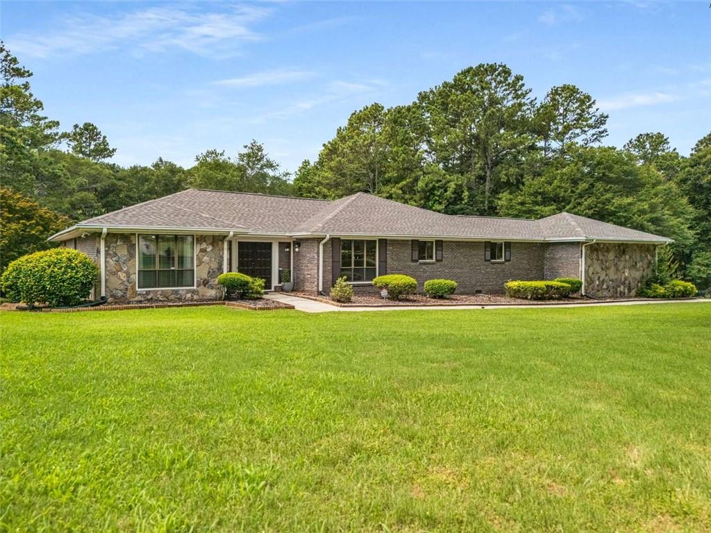 1535 Pathfinder Way Southwest Lilburn, GA 30047 - Photo 4 of 58 a front view of a house with a garden