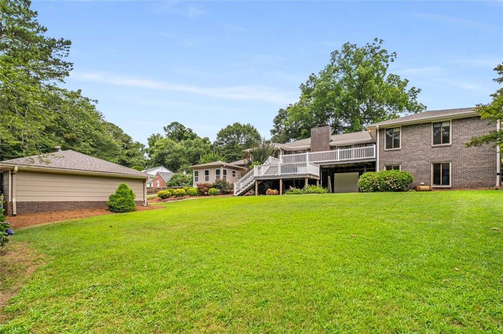 1535 Pathfinder Way Southwest Lilburn, GA 30047 - Photo 46 of 58 a view of a house with a big yard and large trees