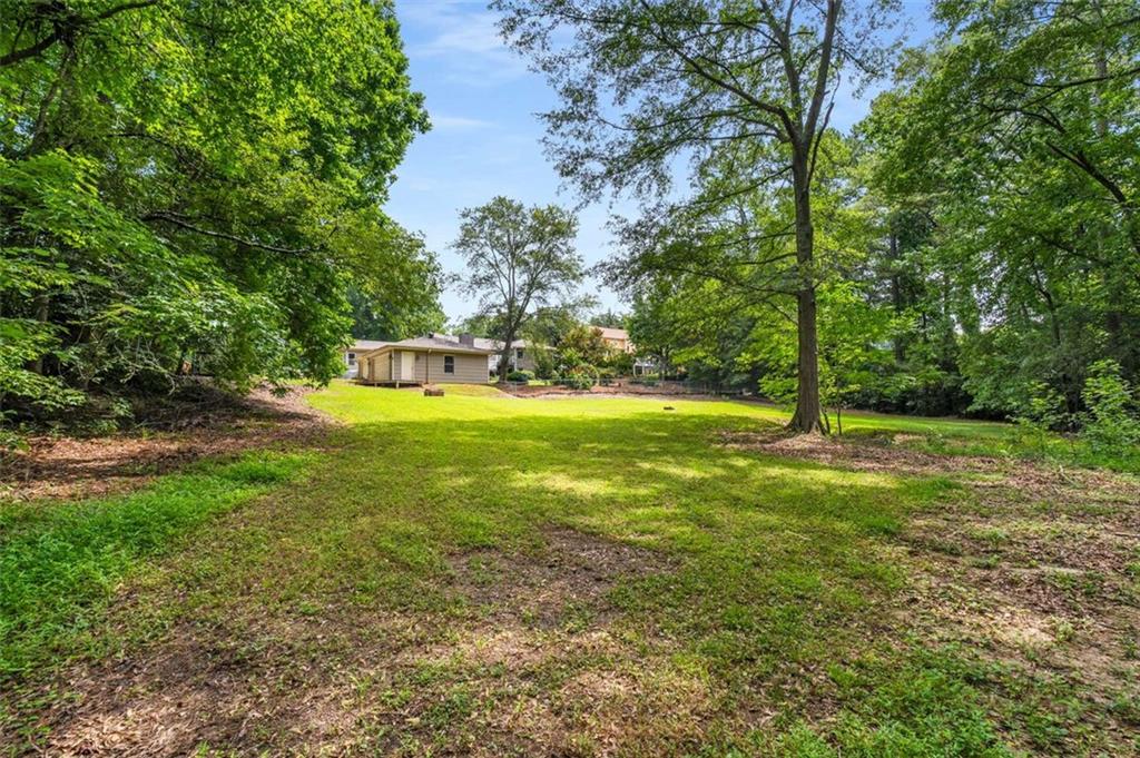 1535 Pathfinder Way Southwest Lilburn, GA 30047 - Photo 48 of 58 a view of a trees with a yard