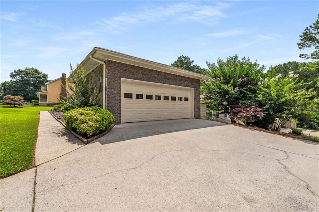 1535 Pathfinder Way Southwest Lilburn, GA 30047 - Photo 50 of 58 a house with a yard and a large parking space