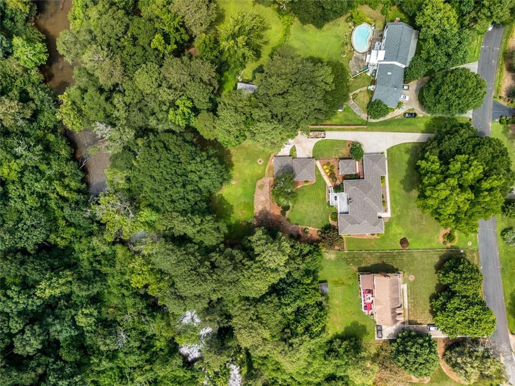 1535 Pathfinder Way Southwest Lilburn, GA 30047 - Photo 51 of 58 an aerial view of a house with a yard and outdoor seating
