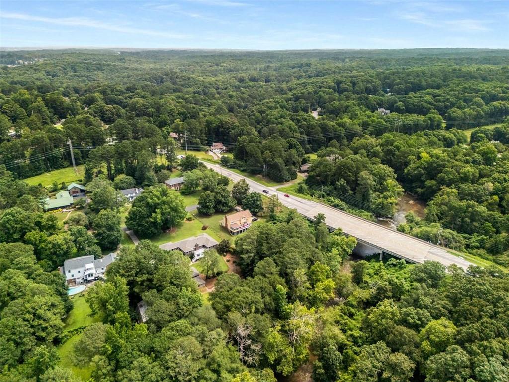1535 Pathfinder Way Southwest Lilburn, GA 30047 - Photo 55 of 58 an aerial view of residential houses with outdoor space and trees