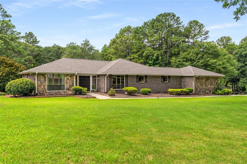 1535 Pathfinder Way Southwest Lilburn, GA 30047 - Photo 56 of 58 a front view of a house with a garden