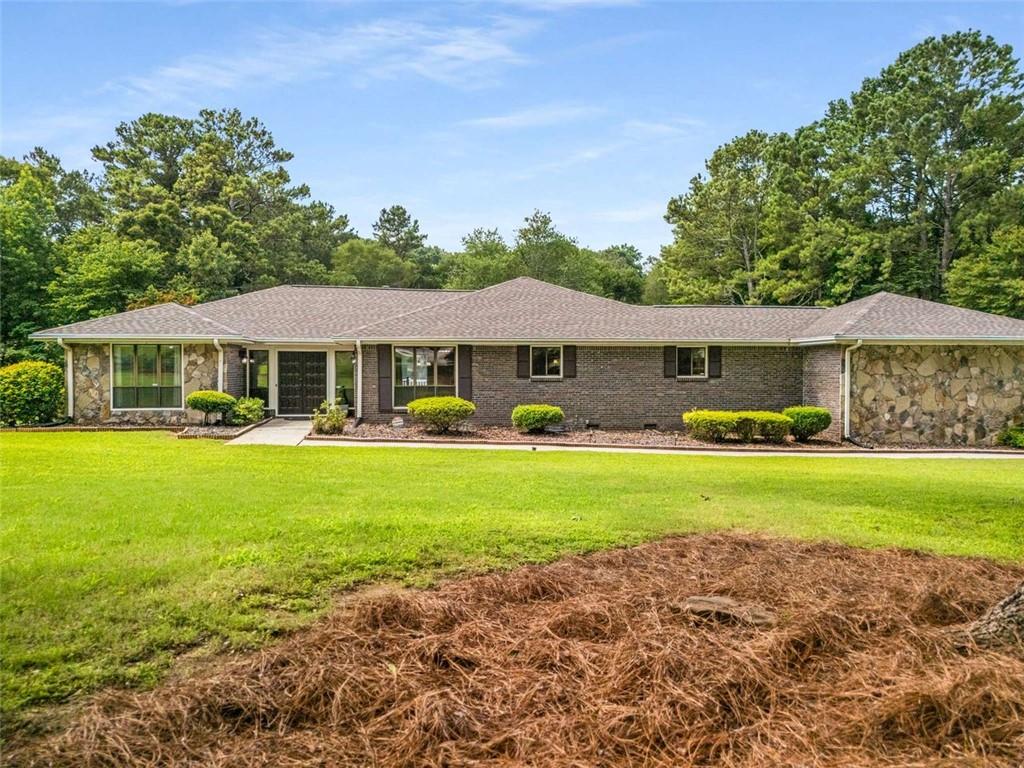 1535 Pathfinder Way Southwest Lilburn, GA 30047 - Photo 58 of 58 a front view of a house with garden