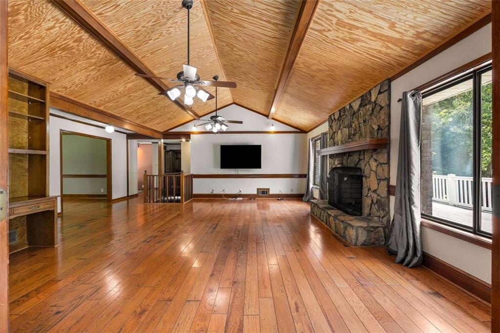 1535 Pathfinder Way Southwest Lilburn, GA 30047 - Photo 7 of 58 a view of a livingroom with wooden floor a fireplace and window