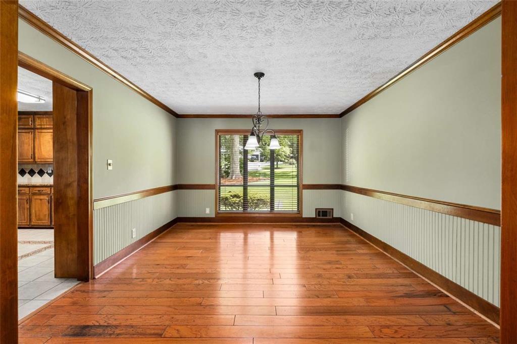 1535 Pathfinder Way Southwest Lilburn, GA 30047 - Photo 9 of 58 a view of an empty room with window and wooden floor