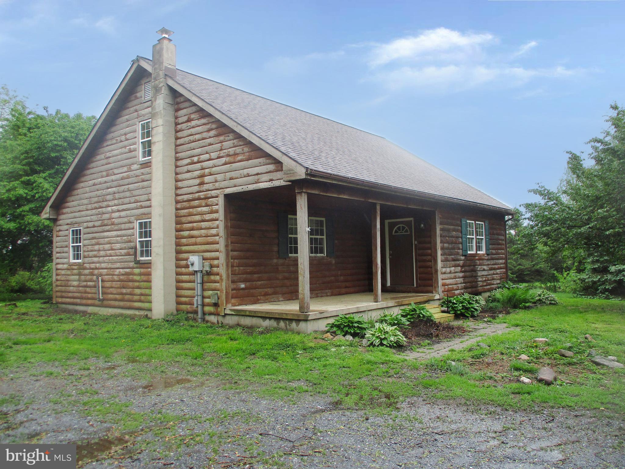 a view of a house with yard and a garden