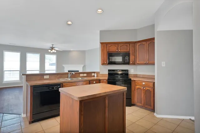 a kitchen with a stove top oven and sink