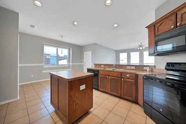 a kitchen with stainless steel appliances granite countertop a stove and a sink
