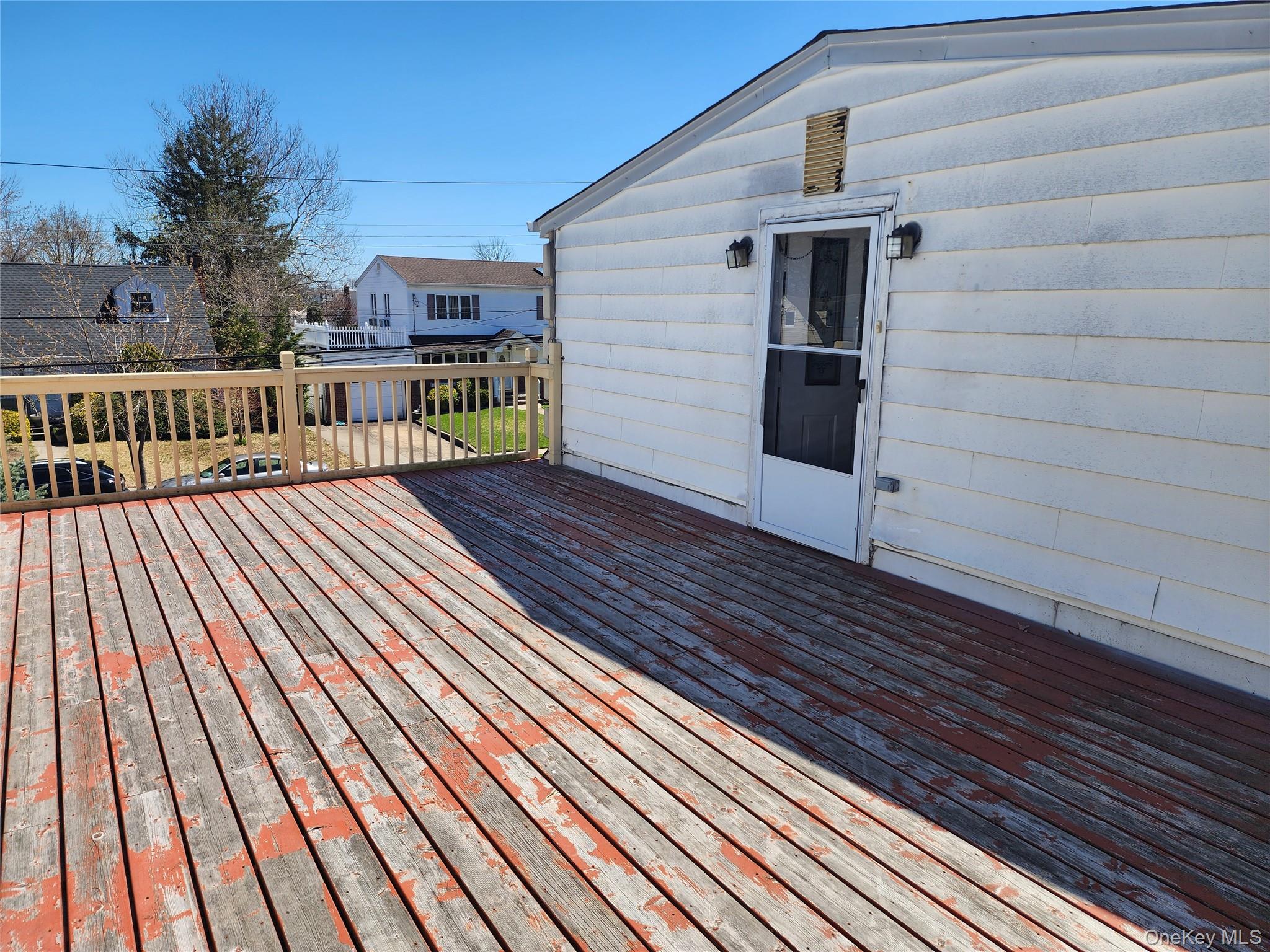 441 Morris Drive Valley Stream, NY 11580 - Photo 9 of 15 a view of backyard with deck and wooden floor