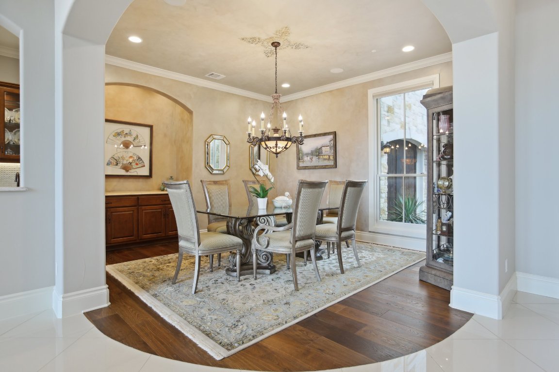 1353 Osprey Ridge Loop Lago Vista, TX 78645 - Photo 12 of 40 a view of a dining room with furniture and wooden floor