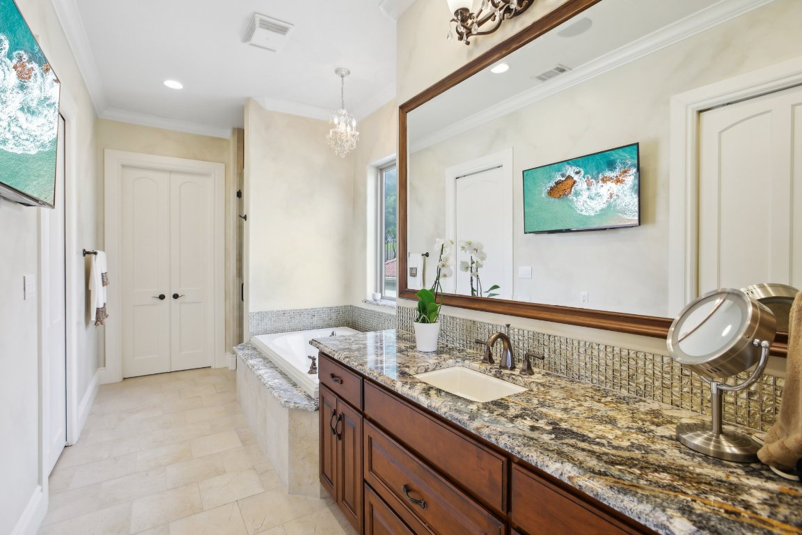 1353 Osprey Ridge Loop Lago Vista, TX 78645 - Photo 15 of 40 a bathroom with a granite countertop sink and a mirror