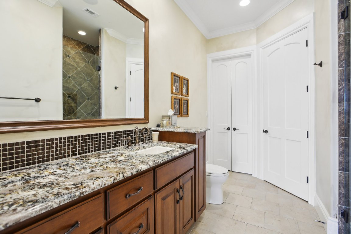 1353 Osprey Ridge Loop Lago Vista, TX 78645 - Photo 16 of 40 a bathroom with a granite countertop sink and a mirror